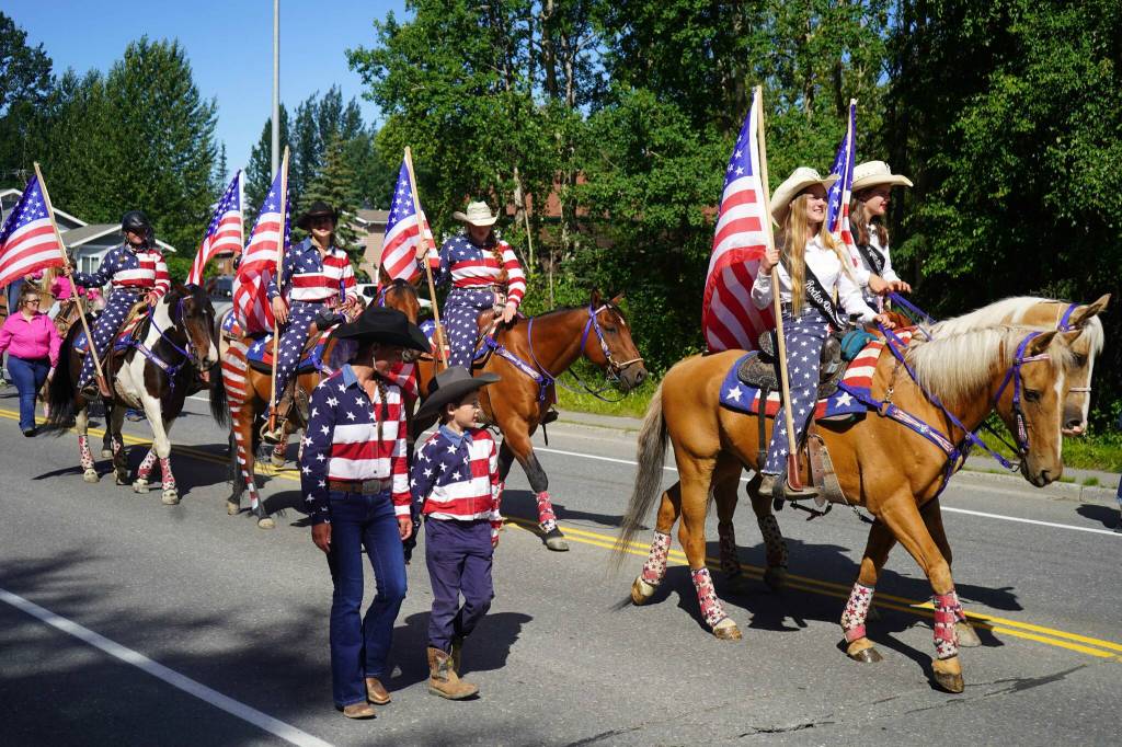 Rodeo-goers walk with the 67th Annual Soldotna Progress Days Parade on Marydale Avenue in Soldotna, Alaska, on Saturday, July 27, 2024. (Jake Dye/Peninsula Clarion)