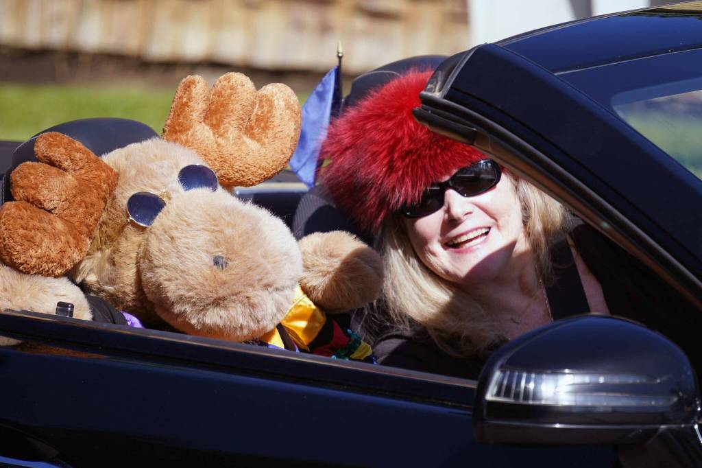 A driver with the Kaknu Kruzers smiles with her passenger moose while rolling with the 67th Annual Soldotna Progress Days Parade on Marydale Avenue in Soldotna, Alaska, on Saturday, July 27, 2024. (Jake Dye/Peninsula Clarion)