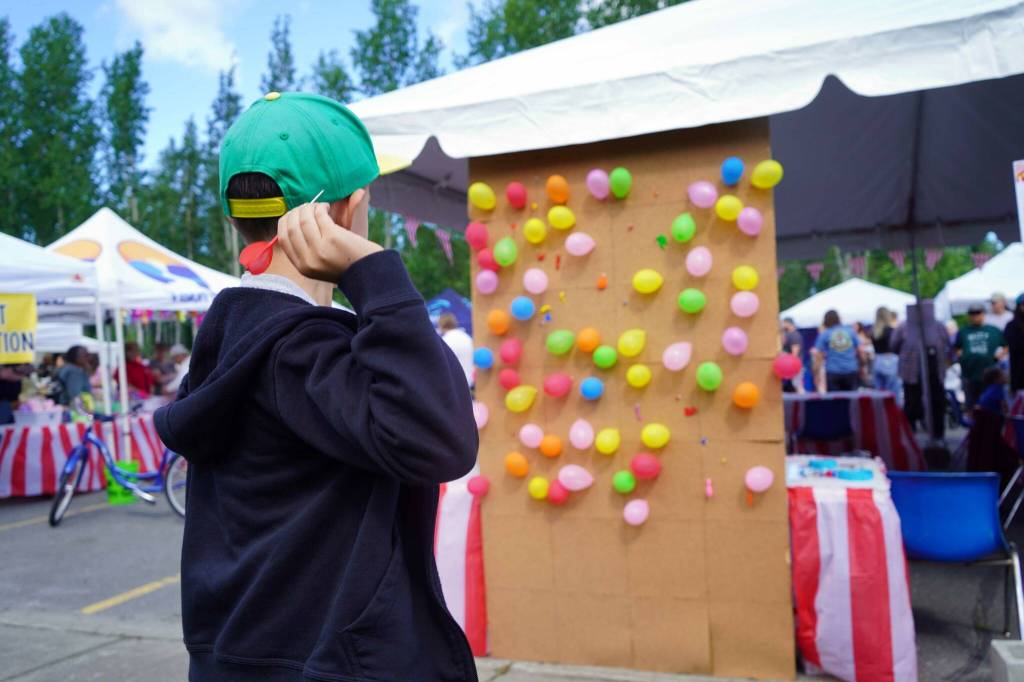 Children participate in a balloon pop during the Progress Days Block Party at Parker Park in Soldotna, Alaska, on Saturday, July 27, 2024. (Jake Dye/Peninsula Clarion)