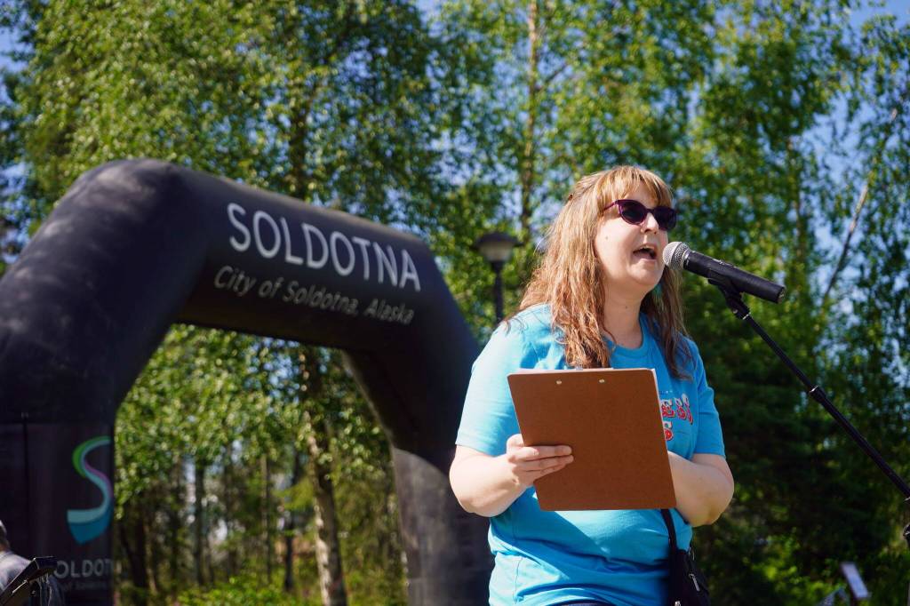 Soldotna Chamber of Commerce Tourism & Education Manager Sara Hondel makes announcements during the Progress Days Block Party at Parker Park in Soldotna, Alaska, on Saturday, July 27, 2024. (Jake Dye/Peninsula Clarion)