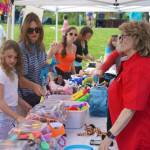 Children and parents mull their options while redeeming tickets during the Progress Days Block Party at Parker Park in Soldotna, Alaska, on Saturday, July 27, 2024. (Jake Dye/Peninsula Clarion)
