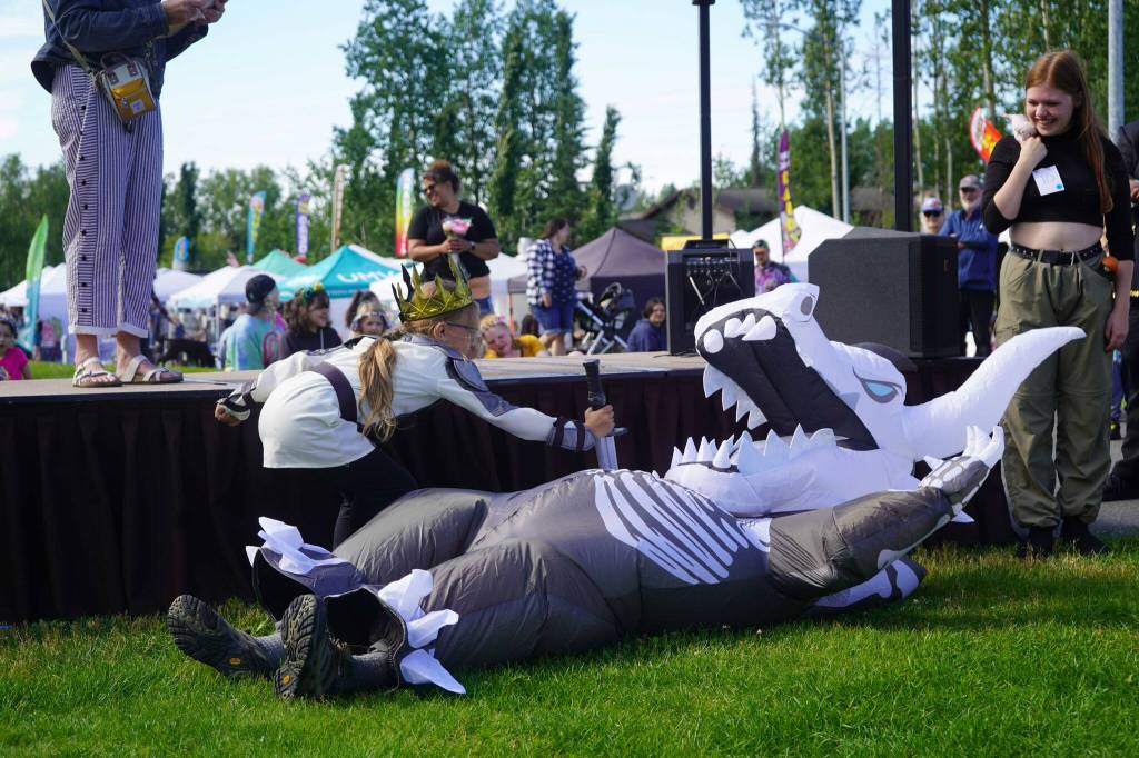 Queen Pip the Dragon Slayer slays a dragon during the Kenai Performers Cosplay Costume Contest at the Soldotna Progress Days Block Party in Parker Park in Soldotna, Alaska, on Saturday, July 27, 2024. (Jake Dye/Peninsula Clarion)