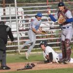Peninsula Oilers Aidan Sullivan is tagged out by Anchorage Glacier Pilots catcher Rodrigo Barajas on Monday, July 29, 2024, at Coral Seymour Memorial Park in Kenai, Alaska. Sullivan was trying to score the winning run in the bottom of the ninth. Pilots pitcher Evan Chadwick celebrates in the background. (Photo by Jeff Helminiak/Peninsula Clarion)