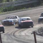 Lane Petersen (far left) leads the pack on the way to victory in Heat 1 of A Stocks on Saturday, July 27, 2024, at Twin City Raceway in Kenai, Alaska. (Photo by Jeff Helminiak/Peninsula Clarion)