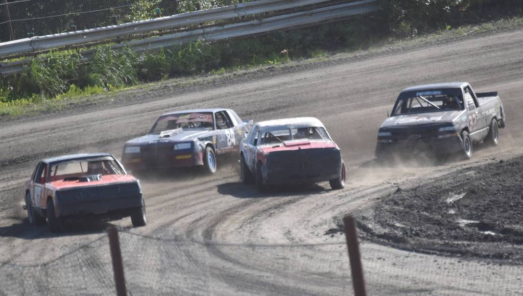 Lane Petersen (far left) leads the pack on the way to victory in Heat 1 of A Stocks on Saturday, July 27, 2024, at Twin City Raceway in Kenai, Alaska. (Photo by Jeff Helminiak/Peninsula Clarion)