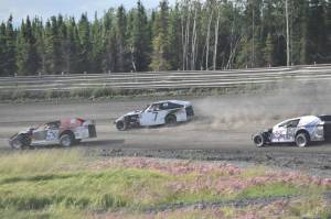Clay Petersen leads Jesse Yancy and Dustin Bass in Heat 1 of Modifieds on Saturday, July 27, 2024, at Twin City Raceway in Kenai, Alaska. Bass would win the race, while Yancy was second and Petersen was third. (Photo by Jeff Helminiak/Peninsula Clarion)