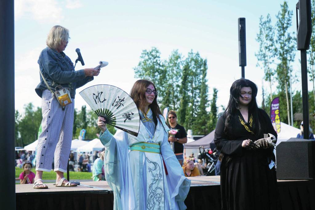 Zoe Nelson and Sarah Anne Sulzer show off their cosplay from Chinese novel/animation series Heaven Officials Blessing during the Kenai Performers Cosplay Costume Contest at the Soldotna Progress Days Block Party in Parker Park in Soldotna on Saturday, July 27. (Jake Dye/Peninsula Clarion)