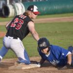 Troy Sanders of the Anchorage Glacier Pilots gets back to first base safely in front of Peninsula Oilers Cody New on Wednesday, July 31, 2024, at Coral Seymour Memorial Park in Kenai, Alaska. (Photo by Jeff Helminiak/Peninsula Clarion)