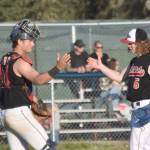 Peninsula Oilers catcher Braden Smith and pitcher Mose Hayes celebrate a victory over the Anchorage Glacier Pilots on Wednesday, July 31, 2024, at Coral Seymour Memorial Park in Kenai, Alaska. (Photo by Jeff Helminiak/Peninsula Clarion)