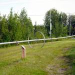 A large sprinkler rests alongside Kenais Field of Flowers in Kenai, Alaska, on Friday, Aug. 2, 2024. (Jake Dye/Peninsula Clarion)