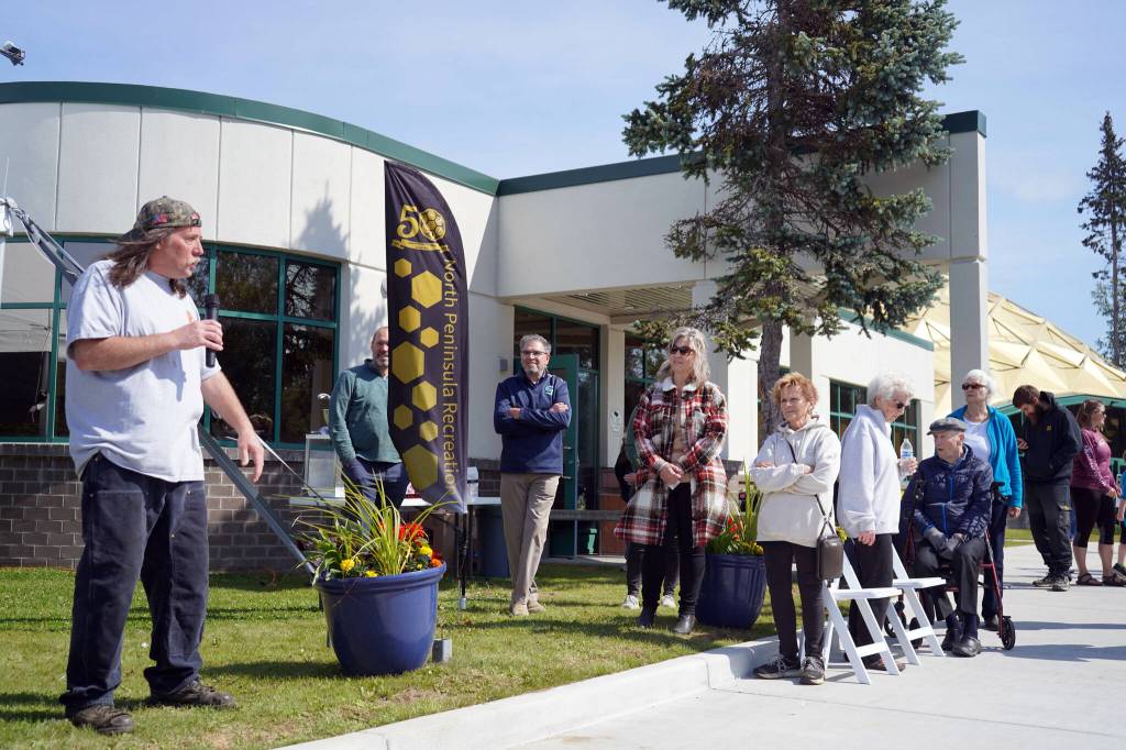 James Knoebel, left, speaks during a celebration of the 50th anniversary of North Peninsula Recreation Service Area while past and present members of the service area board stand nearby at the Nikiski Pool in Nikiski, Alaska, on Saturday, Aug. 3, 2024. (Jake Dye/Peninsula Clarion)