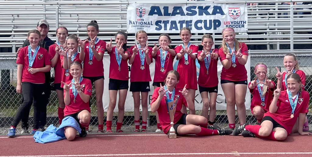 The Kenai Kicks of the Kenai Peninsula Soccer Club won the U13 title at the Alaska Youth State Cup on Sunday, Aug. 4, 2024, at Kenai Central High School in Kenai, Alaska. Back row, left to right: Emery Kingery, coach Scott Bloom, Svea Miller, Kemberly Mills, Lily Hough, Avi Bloom, Sydney Wortham, Morgan Berger, Bryan Hill, Peyton Barber, Addie Moore. Front row, left to right: Elizabeth Backstrom, Raegen Lingenfelter, Morgan Buckbee, Serena Bowen, Ryanne Lingenfelter. (Photo provided)