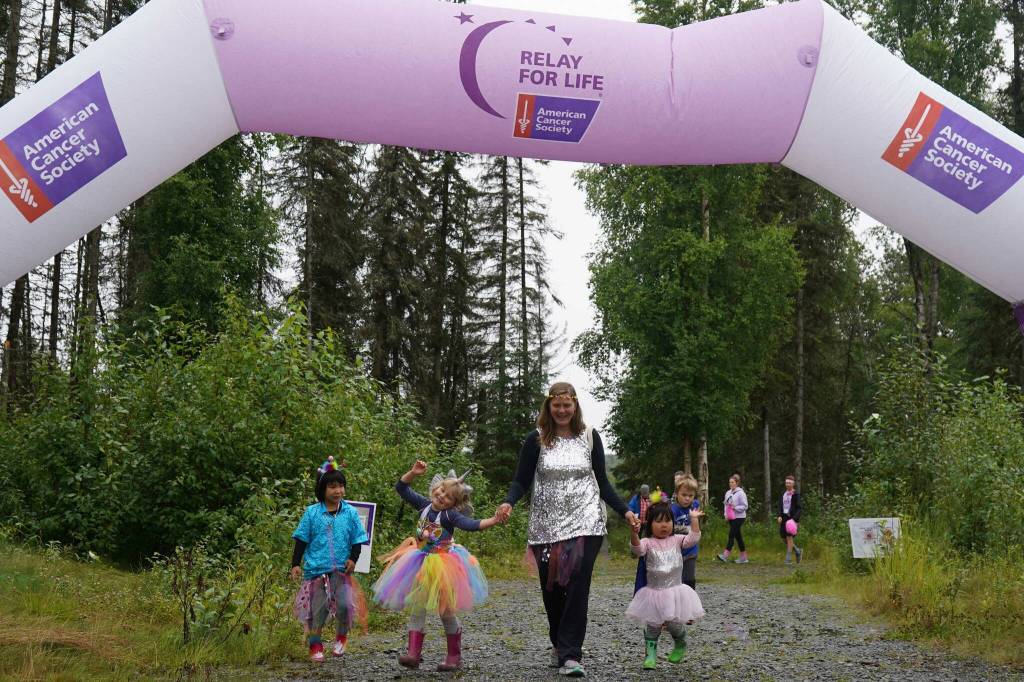 Racers celebrate completing the Brewery to Bathroom .5K The Race for the Rest of Us at Kenai River Brewing in Soldotna, Alaska, on Saturday, Aug. 11, 2024. (Jake Dye/Peninsula Clarion)