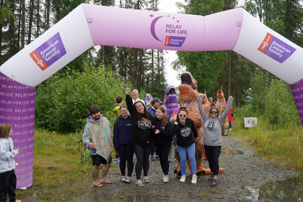 Racers celebrate completing the Brewery to Bathroom .5K The Race for the Rest of Us at Kenai River Brewing in Soldotna, Alaska, on Saturday, Aug. 11, 2024. (Jake Dye/Peninsula Clarion)