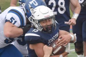 Soldotna's Lokeni Wong fights for yards against Luke Sena (51) and Jason Reese of Palmer on Friday, Aug. 16, 2024, at Justin Maile Field at Soldotna High School in Soldotna, Alaska. (Photo by Jeff Helminiak/Peninsula Clarion)