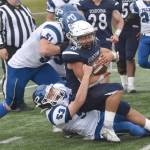 Soldotna's Lokeni Wong fights for yards against Luke Sena (51) and Jason Reese of Palmer on Friday, Aug. 16, 2024, at Justin Maile Field at Soldotna High School in Soldotna, Alaska. (Photo by Jeff Helminiak/Peninsula Clarion)
