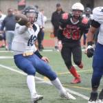 Homer quarterback Preston Stanislaw pitches the ball to running back Justus Grimes on Saturday, Aug. 17, 2024, at Ed Hollier Field at Kenai Central High School in Kenai, Alaska. (Photo by Jeff Helminiak/Peninsula Clarion)