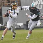 Sewards Brett Gilmore rushes against Nikiskis Lynn Deveer on Saturday, Aug. 17, 2024, at Nikiski Middle-High School in Nikiski, Alaska. (Photo by Jeff Helminiak/Peninsula Clarion)