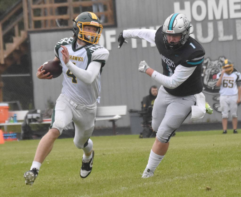 Sewards Brett Gilmore rushes against Nikiskis Lynn Deveer on Saturday, Aug. 17, 2024, at Nikiski Middle-High School in Nikiski, Alaska. (Photo by Jeff Helminiak/Peninsula Clarion)