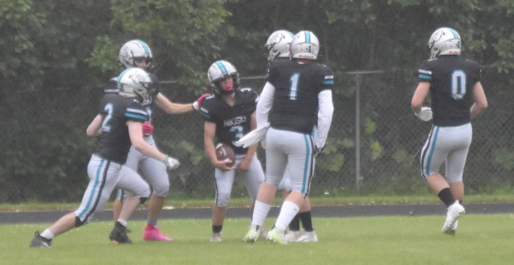 Nikiski celebrates a touchdown by Kaiden Parrish on Saturday, Aug. 17, 2024, at Nikiski Middle-High School in Nikiski, Alaska. (Photo by Jeff Helminiak/Peninsula Clarion)