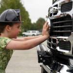 Briar Oden is the first to start pushing a new ambulance into the garage at the Kenai Public Safety Building in Kenai, Alaska, on Saturday, Aug. 17, 2024. (Jake Dye/Peninsula Clarion)