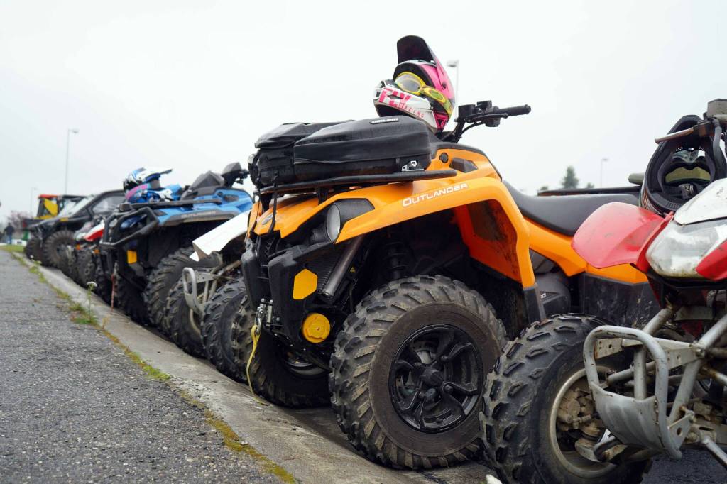 Dozens of ATVs and other off-road vehicles are parked at Nikiski Middle/High School in Nikiski, Alaska, after the Community Ride for Parking Policy Change on Saturday, Aug. 17, 2024. (Jake Dye/Peninsula Clarion)