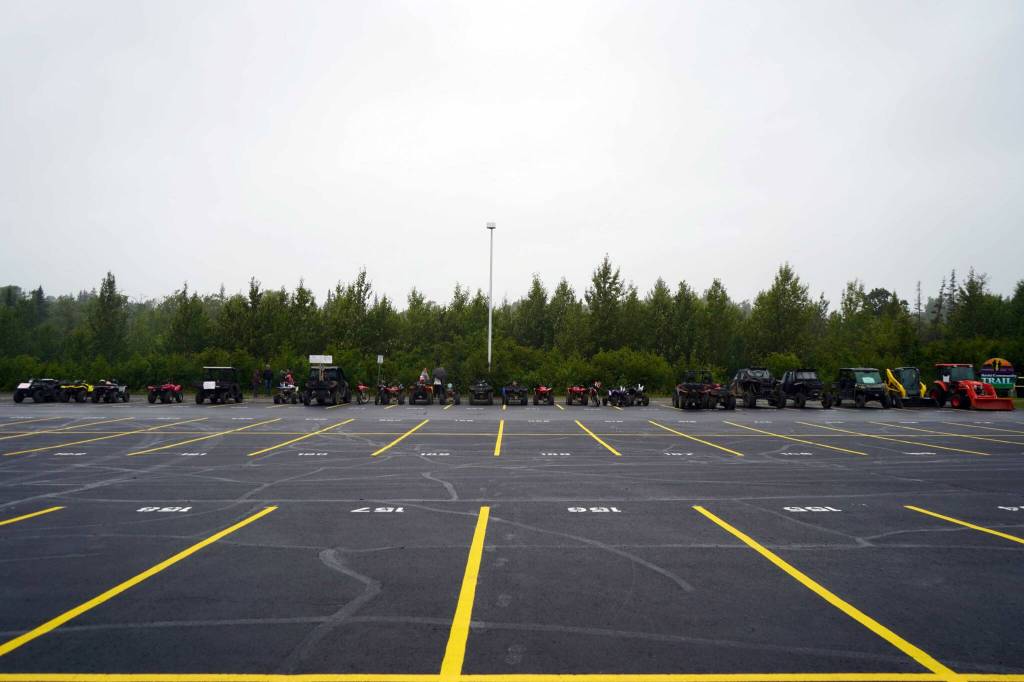 Dozens of ATVs and other off-road vehicles are parked at Nikiski Middle/High School in Nikiski, Alaska, after the Community Ride for Parking Policy Change on Saturday, Aug. 17, 2024. (Jake Dye/Peninsula Clarion)