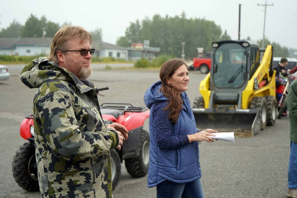 Misty Peterkin, right, speaks moments before the start of the Community Ride for Parking Policy Change outside of M&M Market in Nikiski, Alaska, on Saturday, Aug. 17, 2024. (Jake Dye/Peninsula Clarion)