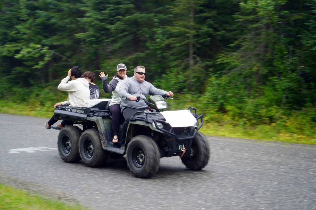 The Community Ride for Parking Policy Change rolls up the driveway of Nikiski Middle/High School in Nikiski, Alaska, on Saturday, Aug. 17, 2024. (Jake Dye/Peninsula Clarion)