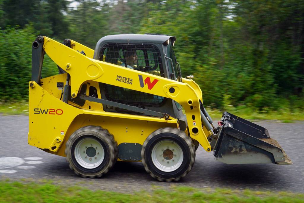 The Community Ride for Parking Policy Change rolls up the driveway of Nikiski Middle/High School in Nikiski, Alaska, on Saturday, Aug. 17, 2024. (Jake Dye/Peninsula Clarion)