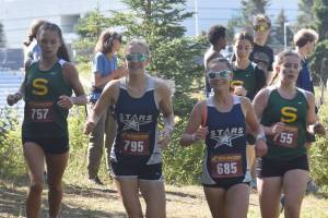 Seward's Olive Jordan, Soldotna's Kathryn DeBardelaben, Soldotna's Kathryn Cox and Seward's Selah Brueckner compete in the freshmen-sophomore girls race Monday, Aug. 19, 2024, at Nikiski Middle-High School in Nikiski, Alaska. (Photo by Jeff Helminiak/Peninsula Clarion)