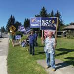 Homer residents hold political signs in support of Alaska House District 6 candidates at WKFL park on Aug. 20, 2024, in Homer, Alaska. (Emilie Springer/ Homer News)