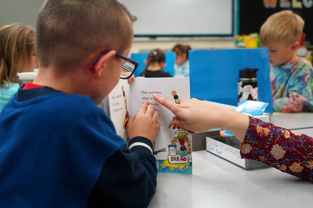 Students sit down to read books on the first day of the school year at Tustumena Elementary School in Kasilof, Alaska, on Wednesday, Aug. 21, 2024. (Jake Dye/Peninsula Clarion)