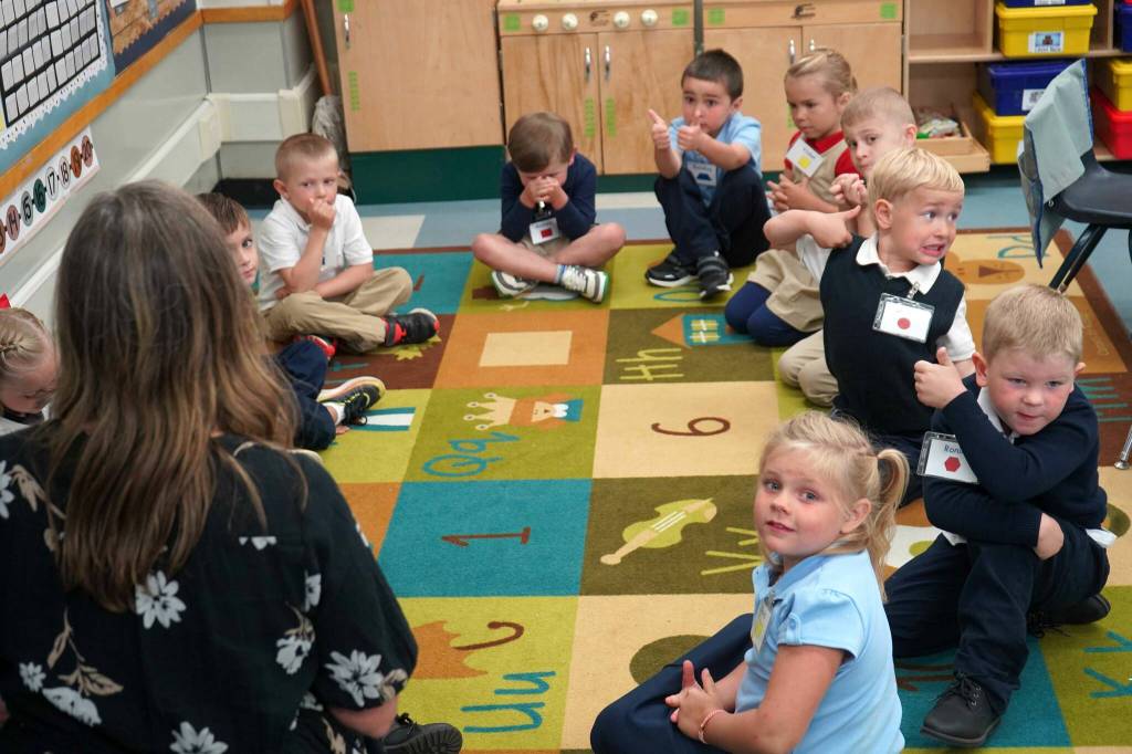 Kindergarteners give thumbs up to their teacher at Aurora Borealis Charter School in Kenai, Alaska, on the first day of the school year Wednesday, Aug. 21, 2024. (Jake Dye/Peninsula Clarion)