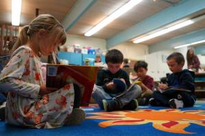 Students sit down to read books on the first day of the school year at Tustumena Elementary School in Kasilof, Alaska, on Wednesday, Aug. 21, 2024. (Jake Dye/Peninsula Clarion)