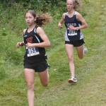Wasillas Hailee Giacobbe leads Soldotnas Tania Boonstra at the Ted McKenney XC Invitational on Saturday, Aug. 24, 2024, at Tsalteshi Trails just outside of Soldotna, Alaska. (Photo by Jeff Helminiak/Peninsula Clarion)