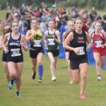 Kenai Centrals Teresa Fallon leads a pack to the finish of the girls varsity race at the Ted McKenney XC Invitational on Saturday, Aug. 24, 2024, at Tsalteshi Trails just outside of Soldotna, Alaska. (Photo by Jeff Helminiak/Peninsula Clarion)