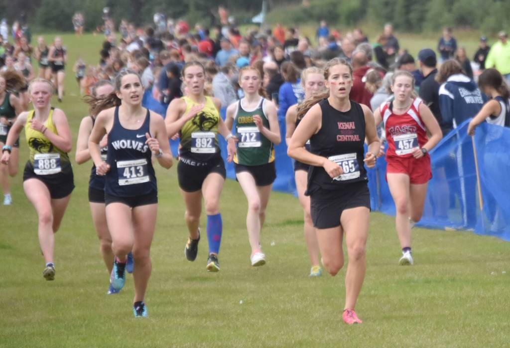 Kenai Centrals Teresa Fallon leads a pack to the finish of the girls varsity race at the Ted McKenney XC Invitational on Saturday, Aug. 24, 2024, at Tsalteshi Trails just outside of Soldotna, Alaska. (Photo by Jeff Helminiak/Peninsula Clarion)
