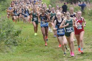 Service's Talia Smith leads the girls varsity race up Angle Hill during the Ted McKenney XC Invitational on Saturday, Aug. 24, 2024, at Tsalteshi Trails just outside of Soldotna, Alaska. (Photo by Jeff Helminiak/Peninsula Clarion)