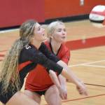 Sophie Tapley and Brynnen Hansen dig up a ball at Kenai Central High School in Kenai, Alaska, on Thursday, Aug. 29, 2024. (Photo by Jeff Helminiak/Peninsula Clarion)