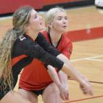 Sophie Tapley and Brynnen Hansen dig up a ball at Kenai Central High School in Kenai, Alaska, on Thursday, Aug. 29, 2024. (Photo by Jeff Helminiak/Peninsula Clarion)