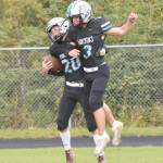 Nikiskis Wyatt Maguire celebrates his touchdown catch with Kaiden Parrish on Saturday, Aug. 31, 2024, at Nikiski Middle-High School in Nikiski, Alaska. (Photo by Jeff Helminiak/Peninsula Clarion)