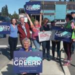 Alaska House District 6 candidate Alana Greear (back, center) poses with supporters at the corner of Pioneer Avenue and Lake Street in Homer during the primary election on Aug. 20, 2024. (Emilie Springer/Homer New)