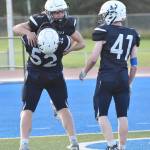 Owen Buckbee (1) celebrates his touchdown with Dalton Armstrong (52) and Chase Hall (41) on Friday, Sept. 6, 2024, at Justin Maile Field in Soldotna, Alaska. (Photo by Jeff Helminiak/Peninsula Clarion)