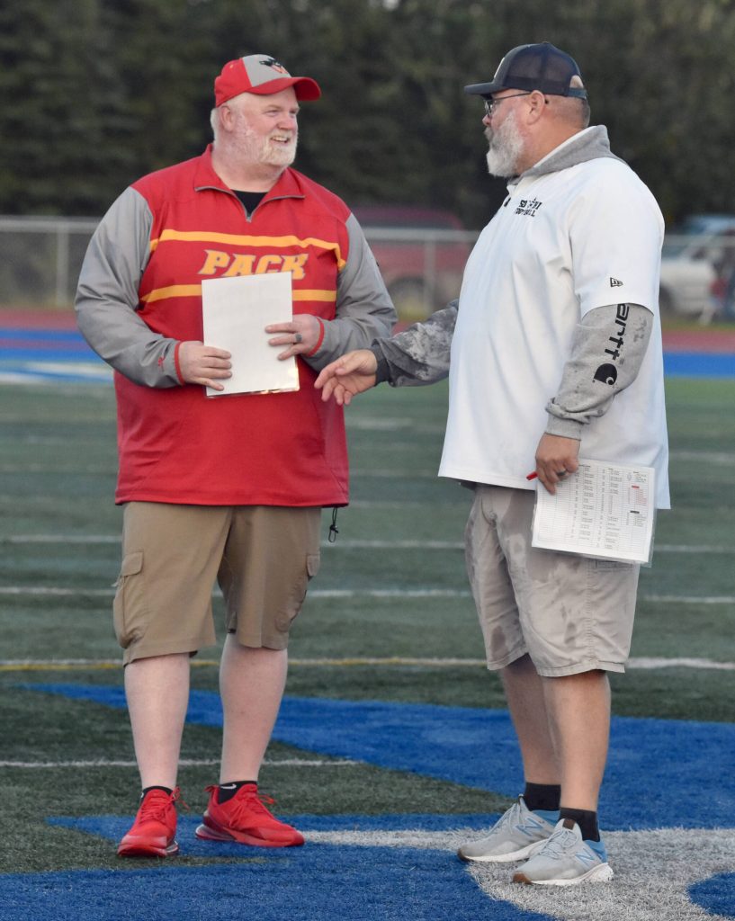 West Valley head coach David DeVaughn, No. 4 on the all-time Alaska wins list at 147, meets after the game with Soldotna head coach Galen Brantley Jr., No. 1 on the wins list with 160, on Friday, Sept. 6, 2024, at Justin Maile Field at Soldotna High School in Soldotna, Alaska. (Photo by Jeff Helminiak/Peninsula Clarion)