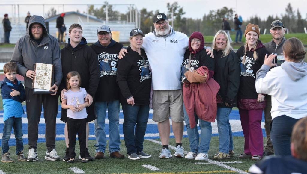 Soldotna head coach Galen Brantley Jr. and family members celebrate Brantley Jr. amassing the most wins in Alaska history Friday, Sept. 6, 2024, at Justin Maile Field at Soldotna High School in Soldotna, Alaska. (Photo by Jeff Helminiak/Peninsula Clarion)