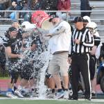 Soldotna head coach Galen Brantley Jr. is doused with water on Friday, Sept. 6, 2024, at Justin Maile Field at Soldotna High School in Soldotna, Alaska. (Photo by Jeff Helminiak/Peninsula Clarion)