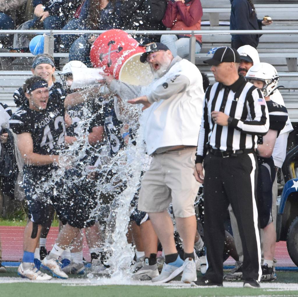 Soldotna head coach Galen Brantley Jr. is doused with water on Friday, Sept. 6, 2024, at Justin Maile Field at Soldotna High School in Soldotna, Alaska. (Photo by Jeff Helminiak/Peninsula Clarion)