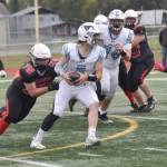 Kenai Centrals Lochlyn Roney (75) and Makai Johansen converge on Chugiaks Sam Young on Saturday, Sept. 7, 2024, at Ed Hollier Field at Kenai Central High School in Kenai, Alaska. (Photo by Jeff Helminiak/Peninsula Clarion)