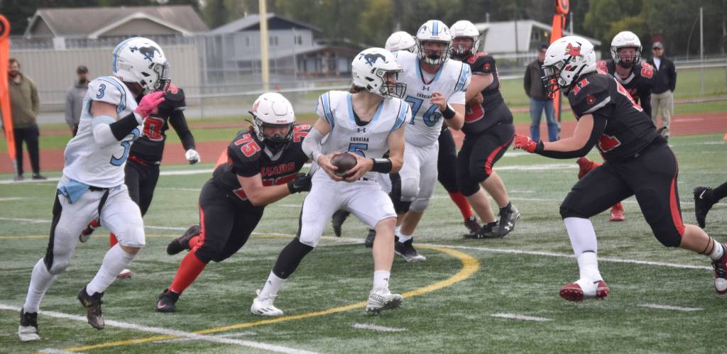 Kenai Centrals Lochlyn Roney (75) and Makai Johansen converge on Chugiaks Sam Young on Saturday, Sept. 7, 2024, at Ed Hollier Field at Kenai Central High School in Kenai, Alaska. (Photo by Jeff Helminiak/Peninsula Clarion)